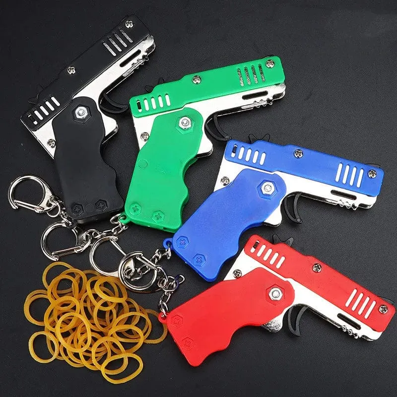 1 stücke Mini Metall Pistole Klapp Gummiband Spielzeug Outdoor Sport Keychain Spielzeug 6 Bursts Gummi Pistole Kinder Geschenke Party favor Pistole Spielzeug