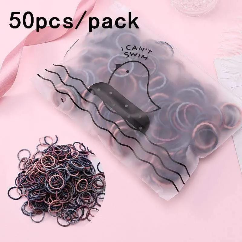 1000 Stück / Packung Mädchen Bunte kleine Einweg-Gummibänder Kinder Pferdeschwanzhalter Elastische Haarbänder Krawatten Mode Haarschmuck