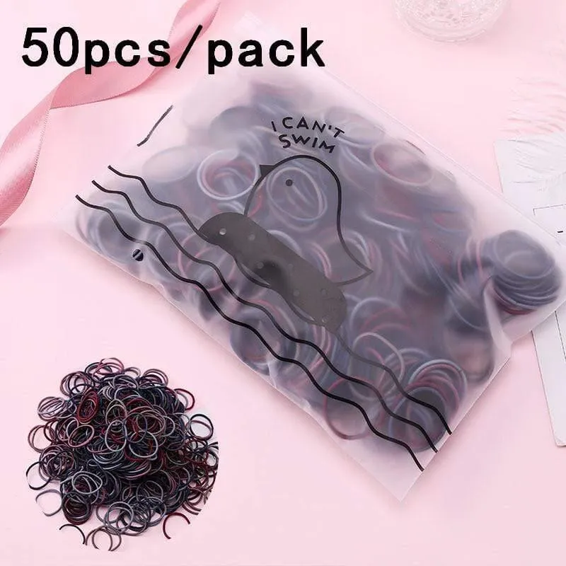 1000 Stück / Packung Mädchen Bunte kleine Einweg-Gummibänder Kinder Pferdeschwanzhalter Elastische Haarbänder Krawatten Mode Haarschmuck