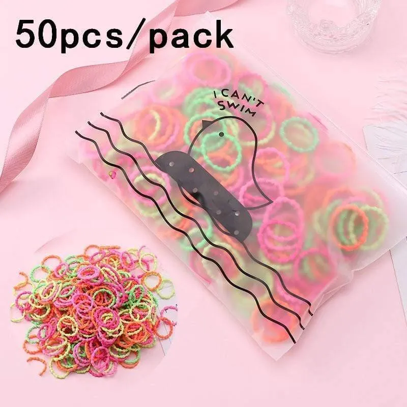 1000 Stück / Packung Mädchen Bunte kleine Einweg-Gummibänder Kinder Pferdeschwanzhalter Elastische Haarbänder Krawatten Mode Haarschmuck