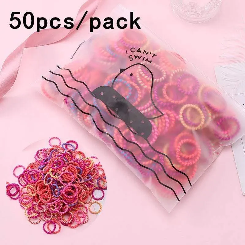 1000 Stück / Packung Mädchen Bunte kleine Einweg-Gummibänder Kinder Pferdeschwanzhalter Elastische Haarbänder Krawatten Mode Haarschmuck